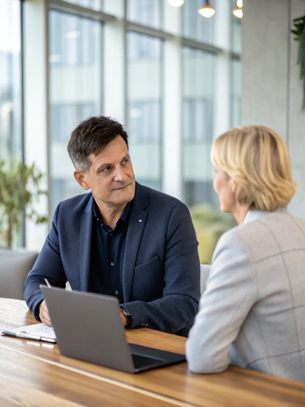 A CEO reflecting thoughtfully in their office, symbolizing self-awareness and personal growth.